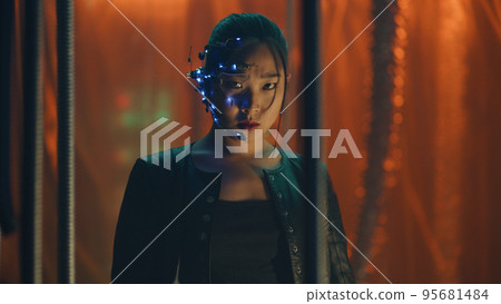 Cyberpunk girl in a leather jacket and headset trapped behind black hanging rods Cyberpunk girl in a leather jacket and headset trapped behind black hanging rods 95681484