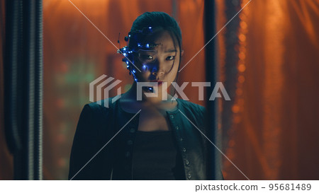 Cyberpunk girl in a leather jacket and headset trapped behind black hanging rods 95681489