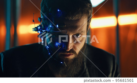 Brunette guy wearing futuristic headset looks with intense expressions Cyberpunk 95681501