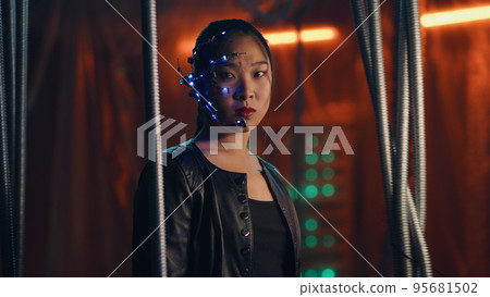Cyberpunk girl in a leather jacket and headset trapped behind black hanging rods 95681502