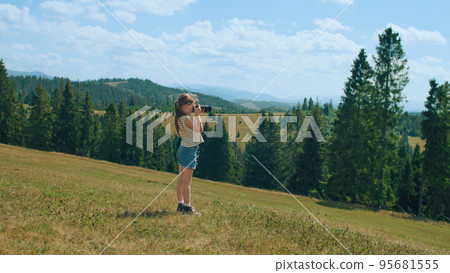 Young girl photographer shooting landscape Young girl photographer shooting landscape 95681555
