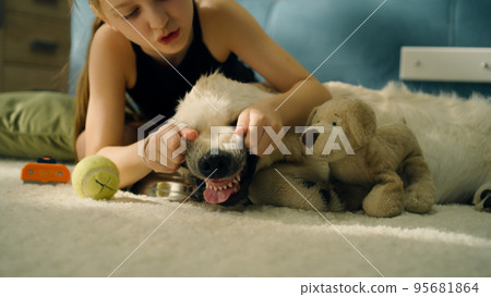 Young girl playing with dog Young girl playing with dog 95681864