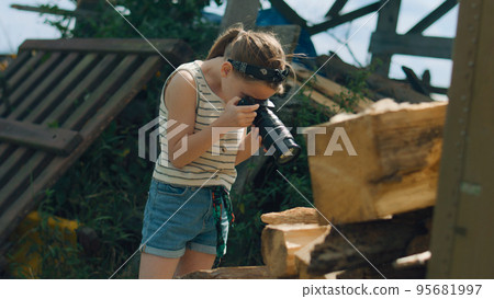 Young girl photographer shooting wooden pattern Young girl photographer shooting wooden pattern 95681997