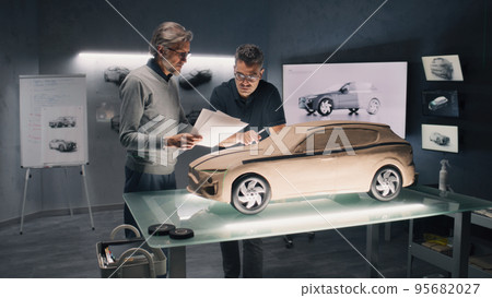 Men working in car design workshop Men working in car design workshop 95682027