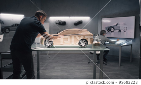 Male designers creating clay car model Male designers creating clay car model 95682228