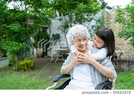 Senior woman in wheelchair and granddaughter girl 95683878