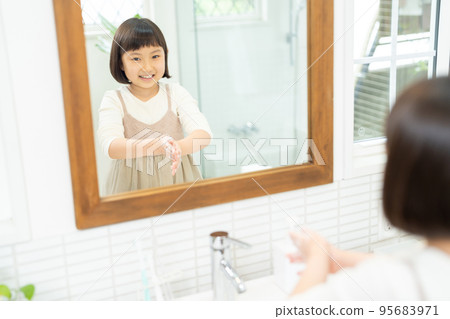 Elementary school girl washing hands in the washroom 95683971