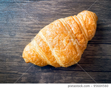Delicious breakfast with fresh croissant on the wood table Delicious breakfast with fresh croissant on the wood table 95684560