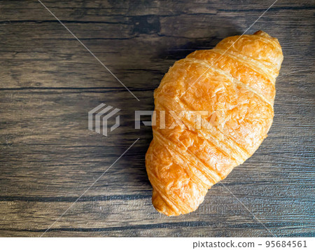 Delicious breakfast with fresh croissant on the wood table Delicious breakfast with fresh croissant on the wood table 95684561