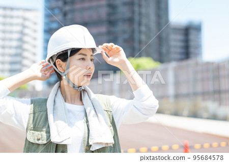 Female worker working at a construction site 95684578