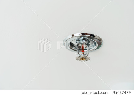 Fire Sprinkler detector mounted on roof in home or apartment. Safety and conflagration security concept 95687479