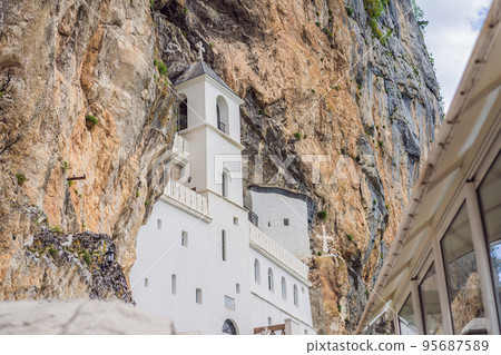 Monastery of Ostrog, Serbian Orthodox Church situated against a vertical background, high up in the large rock of Ostroska Greda, Montenegro. Dedicated to Saint Basil of Ostrog 95687589