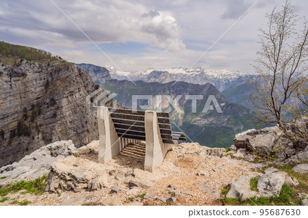 Breathtaking panoramic view of the Grlo Sokolovo gorge in Montenegro. In the foreground is a mountain, the flat side of which forms a cliff, and the ridge is overgrown with trees 95687630