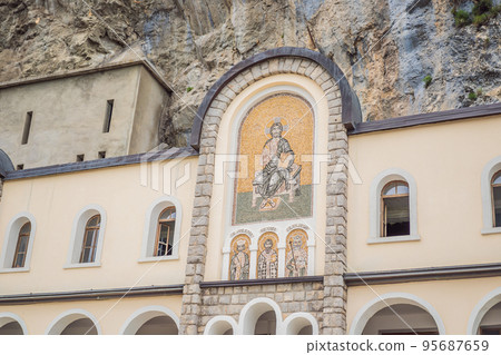 Monastery of Ostrog, Serbian Orthodox Church situated against a vertical background, high up in the large rock of Ostroska Greda, Montenegro. Dedicated to Saint Basil of Ostrog 95687659