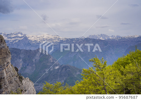 Breathtaking panoramic view of the Grlo Sokolovo gorge in Montenegro. In the foreground is a mountain, the flat side of which forms a cliff, and the ridge is overgrown with trees 95687687