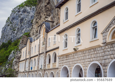 Monastery of Ostrog, Serbian Orthodox Church situated against a vertical background, high up in the large rock of Ostroska Greda, Montenegro. Dedicated to Saint Basil of Ostrog 95687689