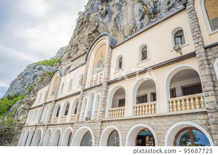 Monastery of Ostrog, Serbian Orthodox Church situated against a vertical background, high up in the large rock of Ostroska Greda, Montenegro. Dedicated to Saint Basil of Ostrog 95687725