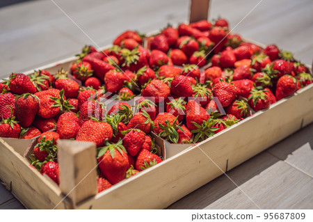 Strawberry box placed on a wooden table, healthy living concept 95687809