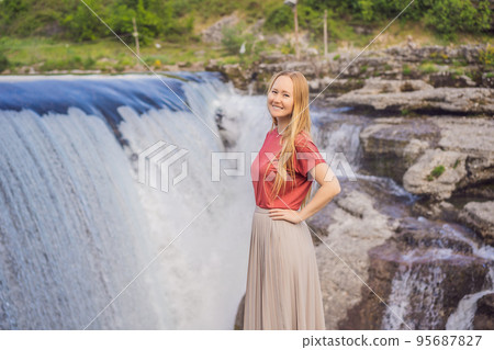 Woman tourist on background of Picturesque Niagara Falls on the river Cievna. Montenegro, near Podgorica. Travel around Montenegro concept Woman tourist on background of Picturesque Niagara Falls on the river Cievna. Montenegro, near Podgorica. Travel around Montenegro concept 95687827