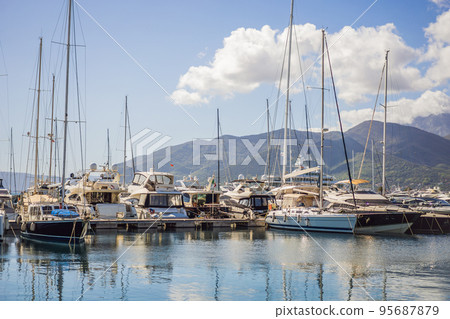 Yacht marina, beautiful Mediterranean landscape in warm colors. Montenegro, Kotor Bay, Tivat city. Porto Montenegro marina view. Go Everywhere Yacht marina, beautiful Mediterranean landscape in warm colors. Montenegro, Kotor Bay, Tivat city. Porto Montenegro marina view. Go Everywhere 95687879