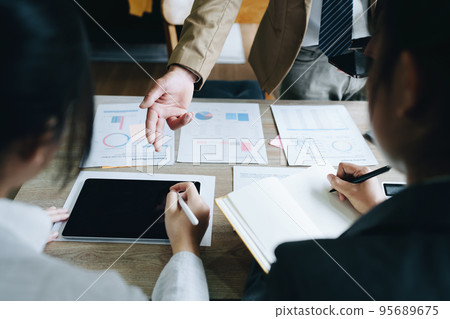 Asian entrepreneurs and business people meeting in a conference room in business planning, financial budget and investment risk assessment to analyze customer groups to increase company growth. Asian entrepreneurs and business people meeting in a conference room in business planning, financial budget and investment risk assessment to analyze customer groups to increase company growth. 95689675