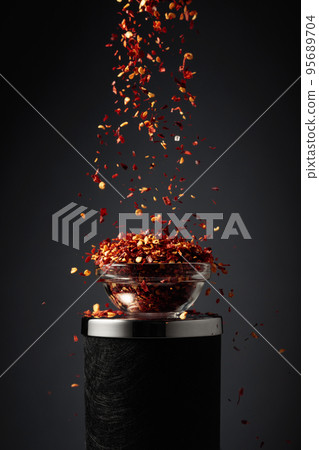 Flakes of red hot chili pepper. 95689704