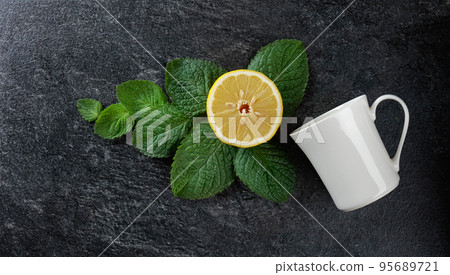 White mug, lemon, and mint. 95689721