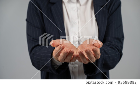 Close-up of caucasian woman holding her palms up. Close-up of caucasian woman holding her palms up. 95689882