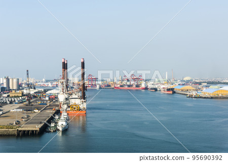 Look over Containers and cranes along the coast of Taichung Port in Taiwan. It is the second-largest port in Taiwan after Kaohsiung Port. 95690392