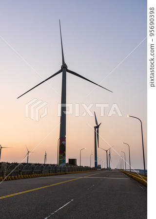 Sunset view of Gaomei Windmill Avenue in Taichung, Taiwan. It's energy systems and renewable energy. The wind power plant, energy systems, and renewable energy are on the west coast of Taiwan. Sunset view of Gaomei Windmill Avenue in Taichung, Taiwan. It's energy systems and renewable energy. The wind power plant, energy systems, and renewable energy are on the west coast of Taiwan. 95690398