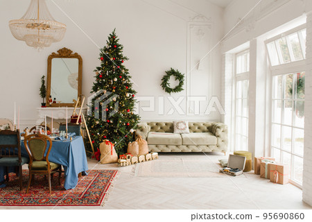 Classic Christmas New Year interior of the room is decorated with a Christmas tree. Christmas tree with gold and red decorations and gift boxes. Christmas Eve at home 95690860