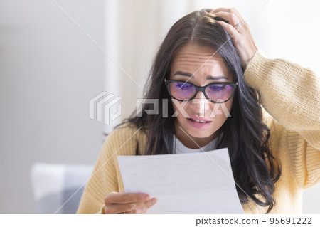 Stressed woman from a reminder because she forgot to pay for energy, mortgage, insurance or invoice 95691222