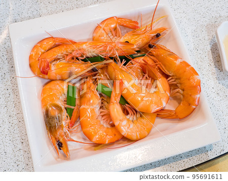 Steamed shrimps with herbs. Seafood, shellfish. Shrimps prawns on plate. Steamed shrimps with herbs. Seafood, shellfish. Shrimps prawns on plate. 95691611