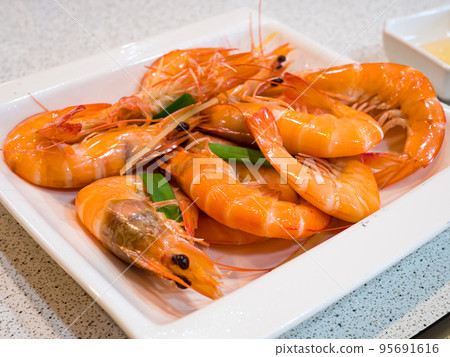 Steamed shrimps with herbs. Seafood, shellfish. Shrimps prawns on plate. Steamed shrimps with herbs. Seafood, shellfish. Shrimps prawns on plate. 95691616