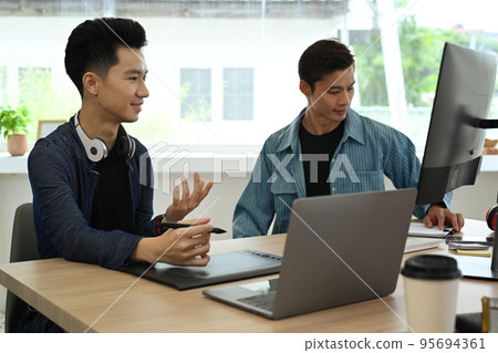 Young creative people discussing online information, sharing idea for new startup project in office 95694361