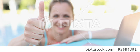 Happy joyful woman show thumbs up on camera, relaxed person on summer holiday Happy joyful woman show thumbs up on camera, relaxed person on summer holiday 95694391