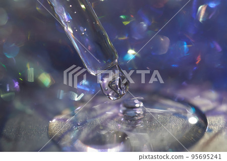 A pipette with a drop of serum in a Christmas theme . A pipette with a drop of serum in a Christmas theme . 95695241