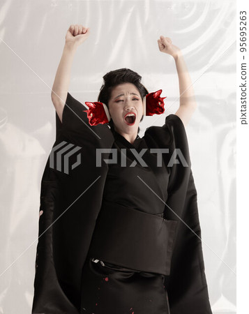 Contemporary art collage. Creative design. Young woman, geisha in black kimono with cat's muzzles on head over white background 95695263