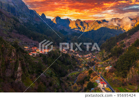 Colorful sunset above Curral Das Freiras village on Madeira Island, Portugal Colorful sunset above Curral Das Freiras village on Madeira Island, Portugal 95695424