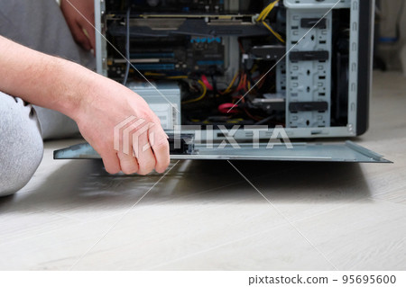 Computer repair. Hands of technician is repairing a computer. Hardware. 95695600