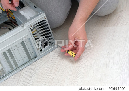 Computer repair. Hands of technician is repairing a computer. Service electronics and computers concept. 95695601