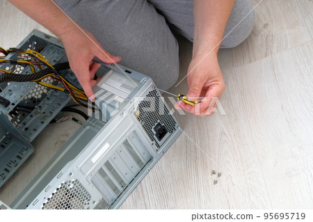 Computer engineer hold screwdriver for repairing PC. Service electronics and computers concept. 95695719