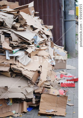 Cardboard and waste paper is collected and packaged for recycling. Pile of cardboard to be recycled. Urban Recycling. 95695955