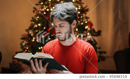 Reading Book Under Christmas Tree in the house 95696319