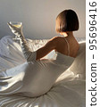 Mobile photo of a young woman with a glass of champagne 95696416