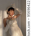 Mobile photo of a young woman with a glass of champagne 95696422