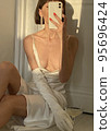 Mobile photo of a young woman with a glass of champagne 95696424