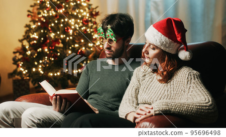 Couple read a book and smile together on Christmas mood 95696498