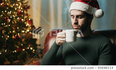Guy with cup in Christmas mood 95696514