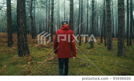 Old man with red jacket explore the misty forest in Autumn season Old man with red jacket explore the misty forest in Autumn season 95696680